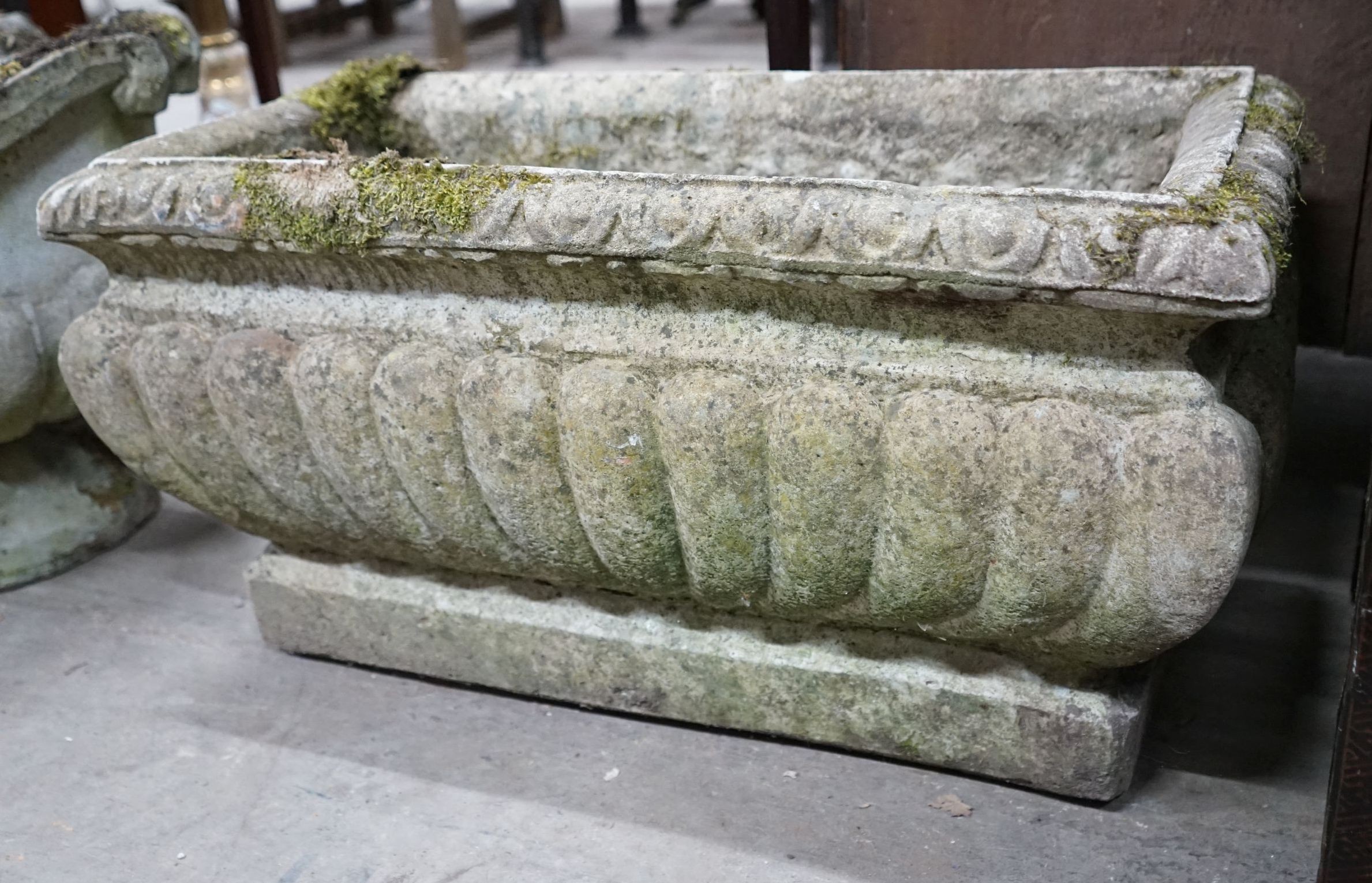 A rectangular reconstituted stone fluted garden planter, width 68cm, depth 32cm, height 36cm